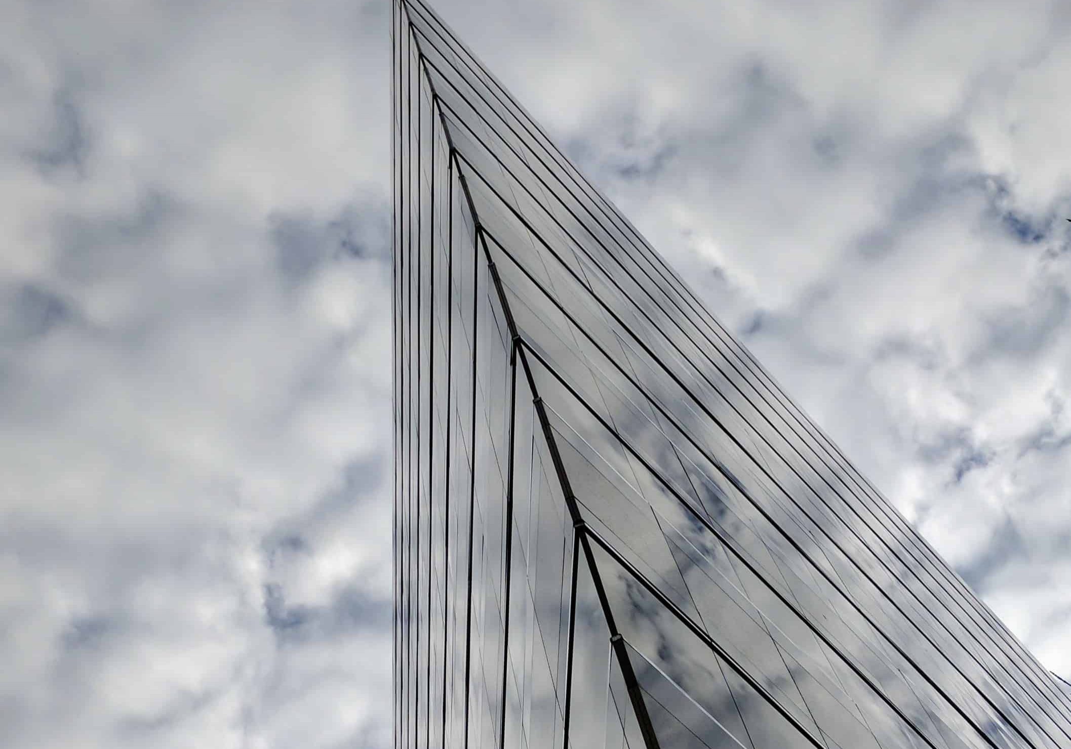 Mirror building under white clouds and blue sky